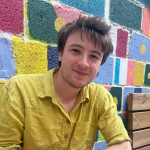 George Wiltshire with background of multi-coloured squares
